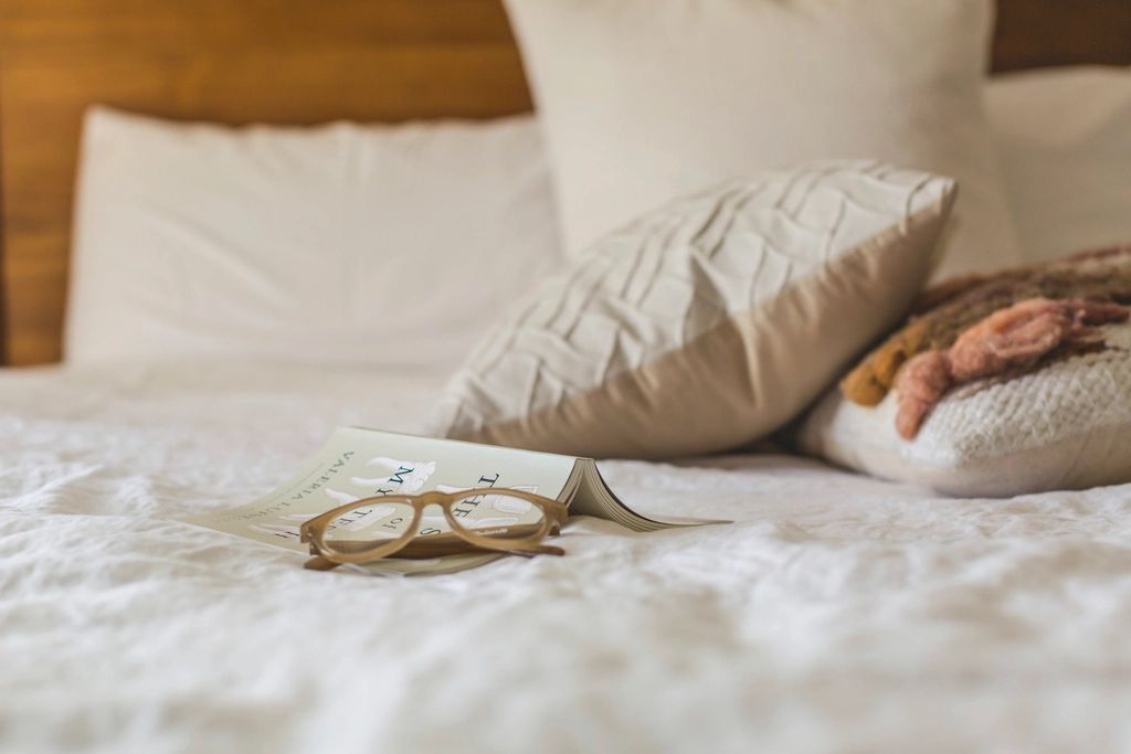 A guest room with a large bed and soft lighting